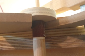 The dowel sanding device in a tight spot where the upper cutout will meet the fretboard, with the flat circular piece of plywood holding it perpendicular to the template surface